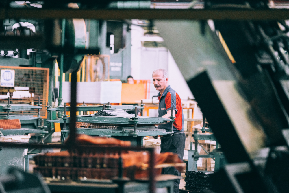 A man in a factory operating a machine