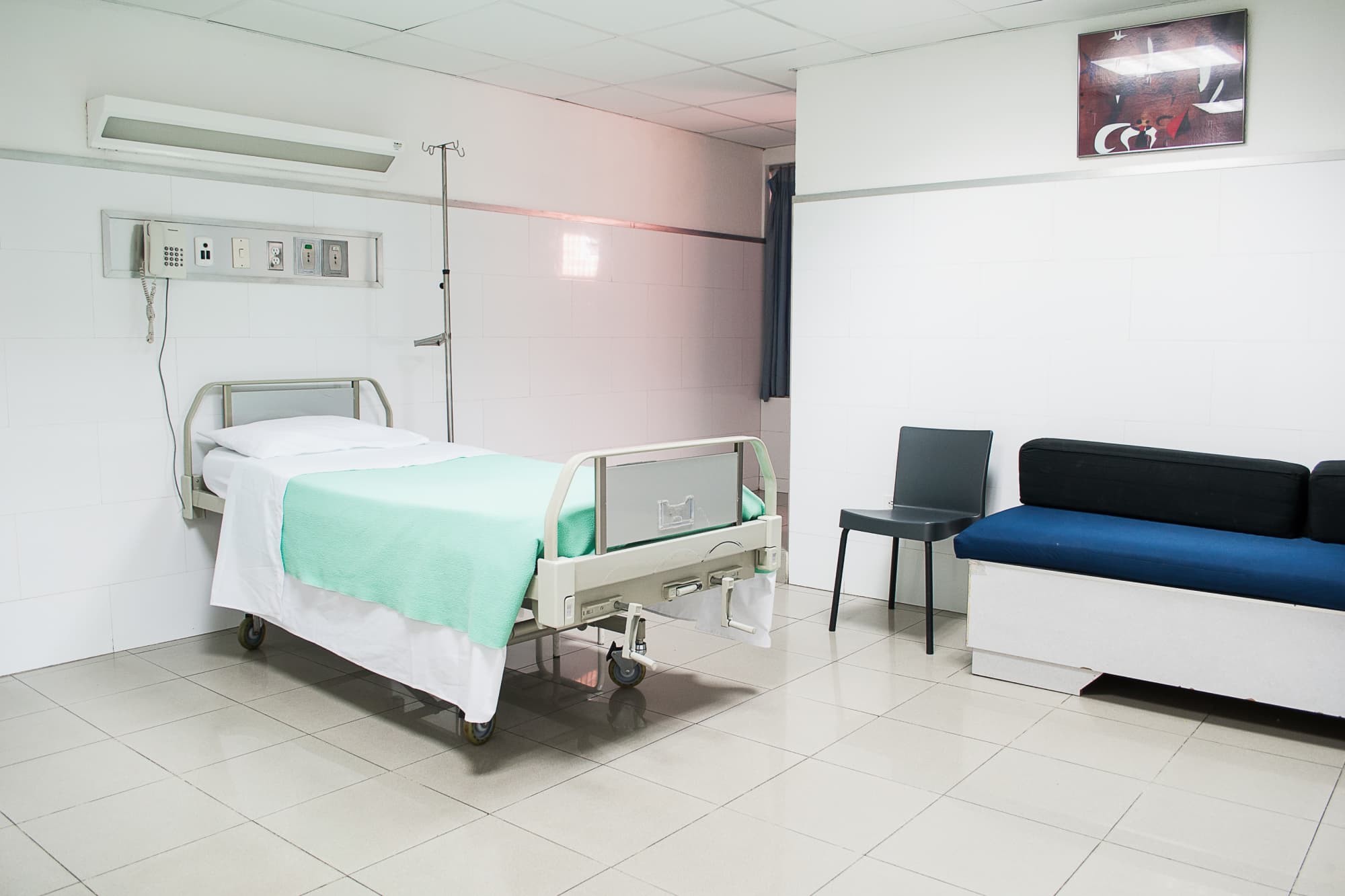 Hospital patient room with a bed and a chair